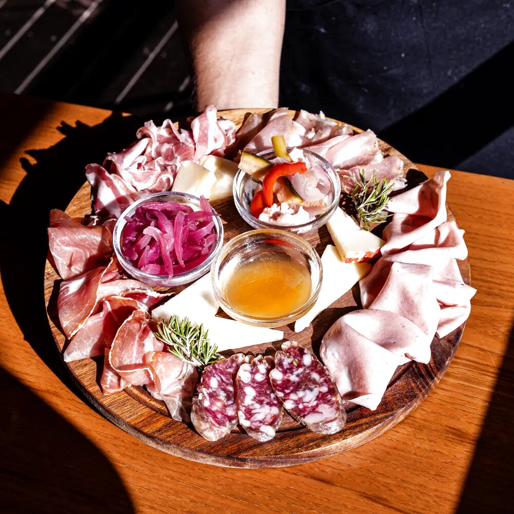 Tagliere di salumi e formaggi con confetture e cipolle in agrodolce